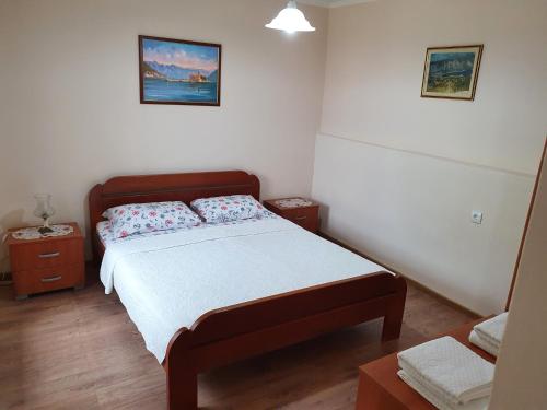 a small bedroom with a bed and two night stands at Apartment Marta in Kotor