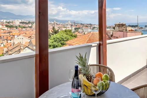 a bowl of fruit on a table on a balcony at Apartment AURELIUS - Panoramic Views - City Center - Marjan Park - Quiet in Split