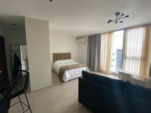 um quarto de hotel com uma cama e uma grande janela em ARKA Classy Apartments em Buenos Aires