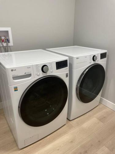 two white washing machines sitting next to each other at Ocean View Oasis in Campbell River