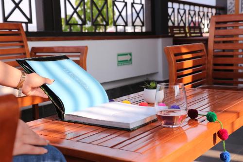 a book sitting on top of a wooden table at The Lu'um House in Tuxtla Gutiérrez