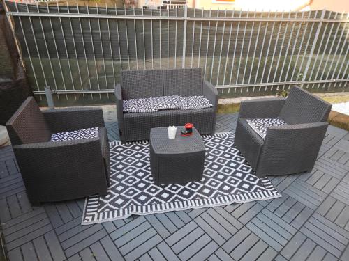 three chairs and a table on a patio at Casa Emily Verona in Verona