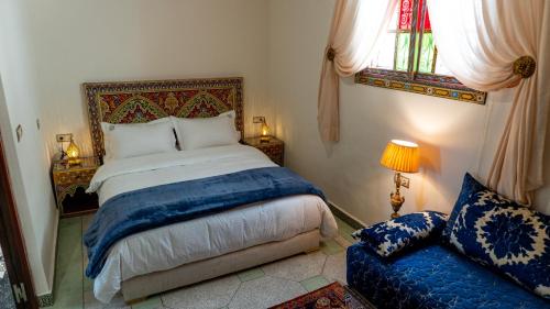 a bedroom with a bed and a couch at Dar Bouzoubaa in Fez
