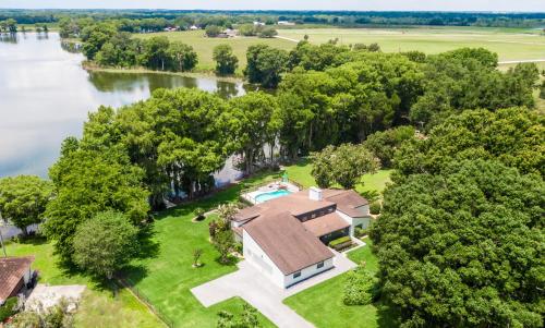 an aerial view of a house on the shore of a river at Mount Dora - Lake Jem in Mount Dora