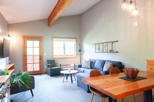 a living room with a blue couch and a table at The Suites on Main in Leavenworth