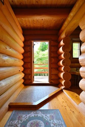 an empty room with a window in a log cabin at 黒川　天空の城 in Minamioguni