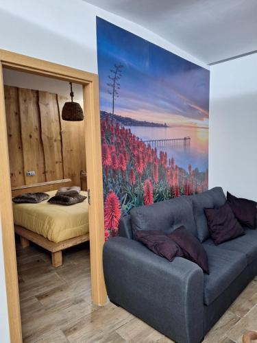a living room with a couch and a bedroom at Recanto do Sol in Vieira do Minho