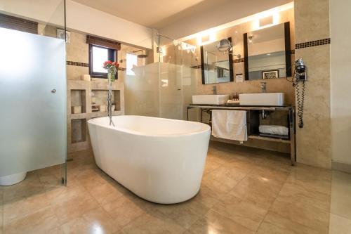 a large bathroom with a tub and a shower at Casa de las Flores Hotel in Oaxaca City