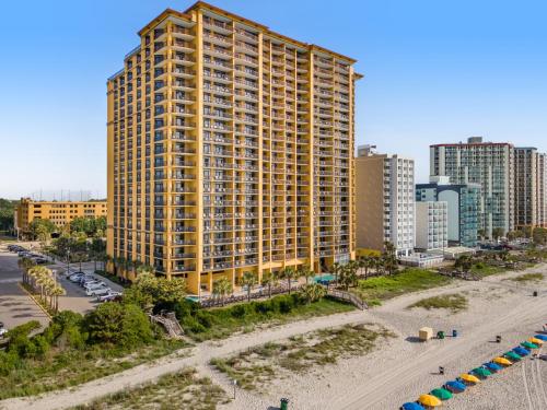an aerial view of a large yellow building on a beach at Anderson Ocean Club and Spa by Oceana Resorts in Myrtle Beach