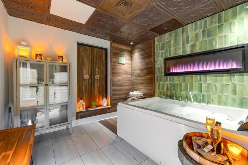 a bathroom with a tub and a wooden ceiling at Anderson Ocean Club and Spa by Oceana Resorts in Myrtle Beach
