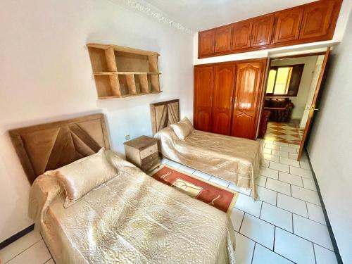 a small room with two beds and a couch at Dar Rachid in Asilah