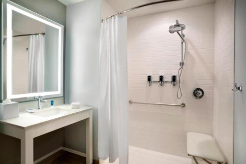 a bathroom with a sink and a shower at Four Points by Sheraton Miami Airport in Miami