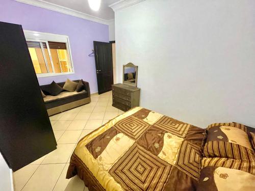 a bedroom with a bed and a couch in a room at Dar Rachid in Asilah
