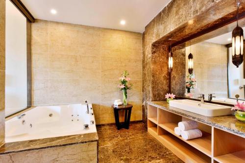 a bathroom with a tub and a sink at Four Points by Sheraton Srinagar in Srinagar