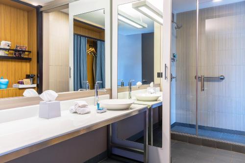 a bathroom with two sinks and a shower at Aloft Lexington in Lexington