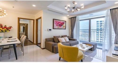 a living room with a couch and a table at Vinhomes Central Park Apartment Landmark Căn hộ DV in Ho Chi Minh City