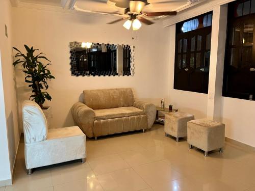 a living room with a couch and two chairs at Hotel Boutique Casa Pere in Cartagena de Indias