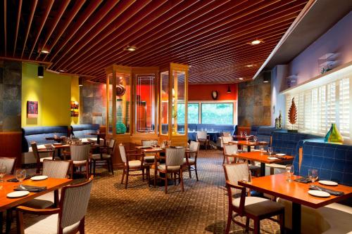 a restaurant with tables and chairs in a room at Four Points by Sheraton Bakersfield in Bakersfield