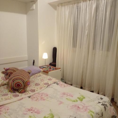 Un dormitorio con una cama con un osito de peluche. en Departamento en Tigre centro en Tigre