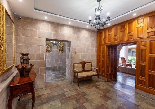 a large bathroom with a bench and a chair at Terra Andina Colonial Mansion in Cusco