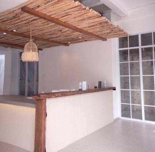 a bar in a room with a wooden ceiling at Little Mykonos in Bandung