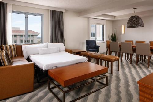 a living room with a couch and a dining room at The Westin Pasadena in Pasadena