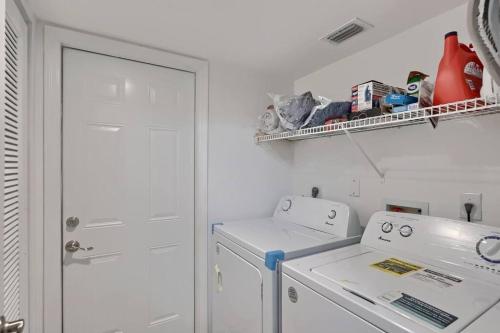 a white laundry room with a washer and dryer at Aster Equestrian Florida Home with Heated Pool/SPA in Wellington