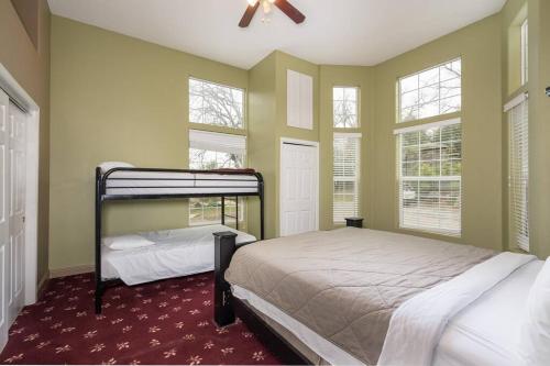 a bedroom with two bunk beds and two windows at Yosemite South Presidential Mansion in Coarsegold
