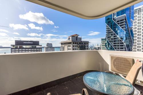 a balcony with a table and a view of the city at Quest on Queen Serviced Apartments in Auckland