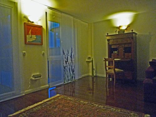 a living room with a table and a chair at Deluxe Apartment in Überlingen