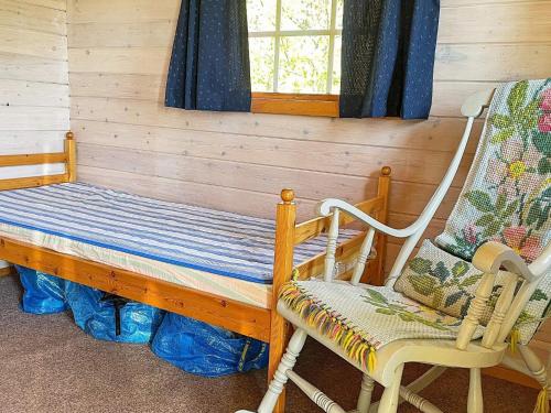 a room with two rocking chairs and a bench at Holiday home Kristinehamn VI in Kristinehamn