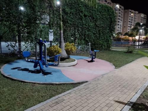 a park with two exercise equipment in the grass at Apto con vista panoramica al nevado del ruiz y del tolima in Ricaurte