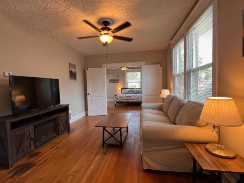 a living room with a couch and a flat screen tv at Rolston 2, Two Bedroom near Xavier Downtown in Bellevue