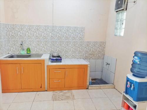 a kitchen with a sink and a counter top at SLAMET HOMESTAY TASIKMALAYA in Tasikmalaya
