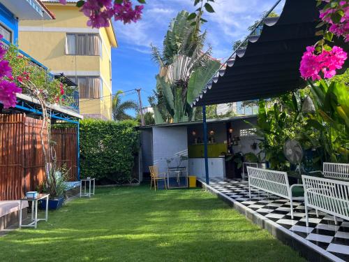 a backyard with benches and a grass yard at Lavini Hoian Boutique Villa in Hoi An