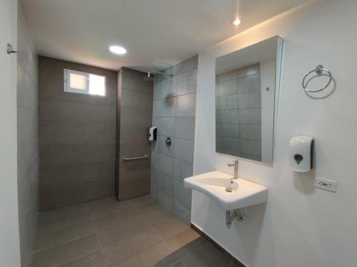 ein Bad mit einem Waschbecken und einer Dusche in der Unterkunft Hotel Villa Bosco in Palmira