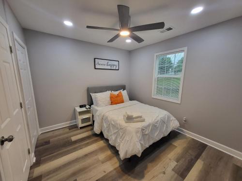 a bedroom with a bed and a ceiling fan at The Silver Cottage in Atlanta