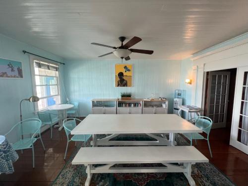 a dining room with a white table and chairs at Inkwell Beach Cottage in Oak Bluffs