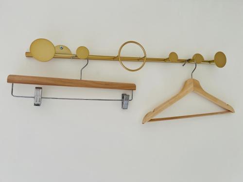 a pair of wooden hangers and glasses on a wall at 日日見宅 Matsuya in Huwei