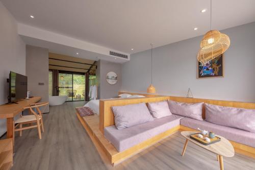 a living room with a couch and a table at Avatar Mountain Resort in Zhangjiajie