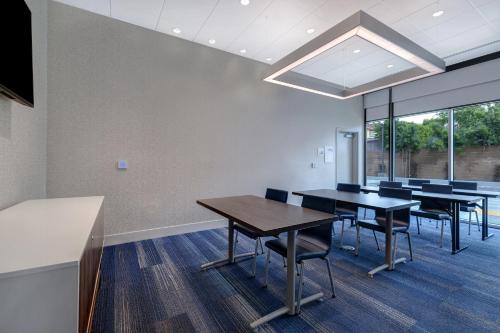 a conference room with tables and chairs and a large skylight at Holiday Inn Express & Suites - Glendale Downtown in Glendale