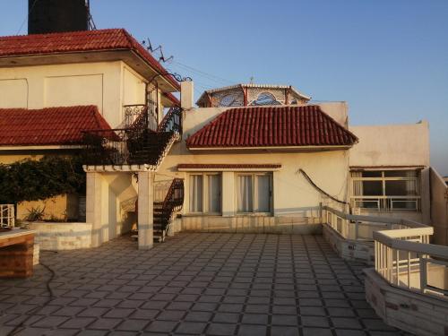 a house with a tiled courtyard in front of it at شقه فى ميامى بالاسكندريه مطله على البحر in Alexandria