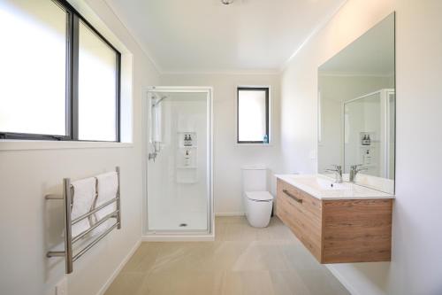 a bathroom with a sink and a shower and a toilet at Redwoods Adventure Base in Rotorua
