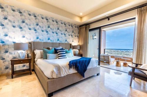 a bedroom with a bed with a view of the ocean at Breathtaking Ocean Views and Access Best Resorts! in Cabo San Lucas