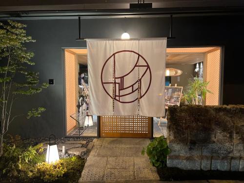 a white curtain on a door with a sign on it at Hotel Legasta Kyoto Higashiyama Sanjo in Kyoto