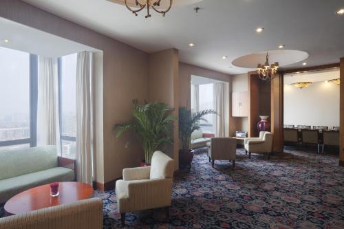 a hotel lobby with chairs and a table and windows at Holiday Inn Temple Of Heaven Beijing by IHG in Beijing