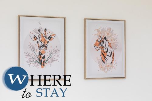 two framed paintings of tigers on a wall with the words where to stay at WhereToStay Apartment River Side in Aberdeen