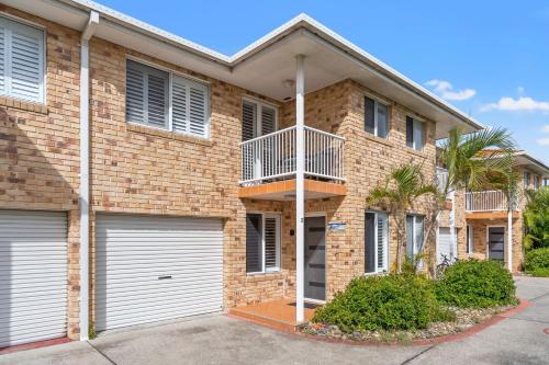 a brick house with two garage doors at Ocean Song - 2-41 Park Street in Evans Head
