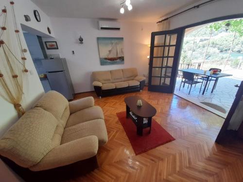 a living room with a couch and a table at Apartment Marin - 40m from sea in Ston