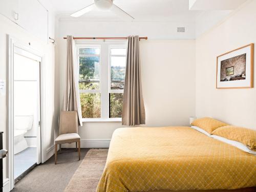 a bedroom with a bed and a window at Lord Wolseley Hotel in Sydney